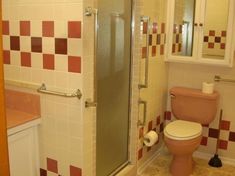 a bathroom with a toilet, shower and sink in it's center area is shown