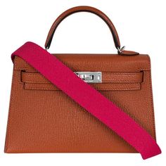 A beautiful Hermès Kelly Mini II handbag. The exterior of this Kelly Mini features Cuivre Ch�èvre Mysore leather and is complemented by palladium hardware and tonal stitchings. It has a front toggle closure with two straps, a single rolled handle and a removable Rose Mexico wooly shoulder strap. The interior is lined in Cuivre Chèvre Mysore leather and features a single slit pocket. The bag is store fresh, full set with factory stickers on all hardware. Date stamp is a U with no surrounding shape Date Stamp, Hermes Box, Mysore, Fashion Handbags, Full Set, Dust Bag, Top Handle Bag, Shoulder Strap, Exterior