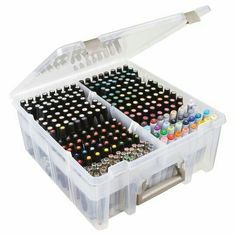 two plastic storage boxes filled with lots of different colored crayons and paint pens