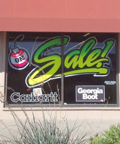 a storefront window with the words sale on it