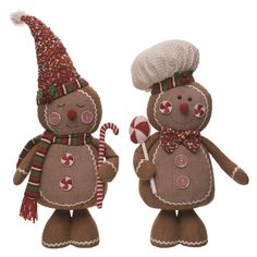 two knitted snowmen standing next to each other with candy canes in their hands