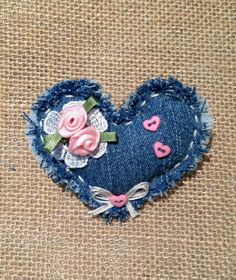 a denim heart with pink roses on it