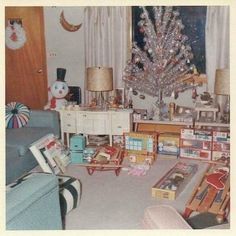 a living room filled with furniture and a christmas tree