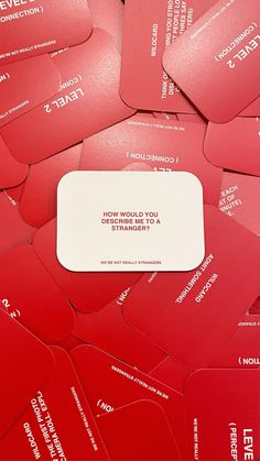 a pile of red business cards sitting next to each other on top of each other