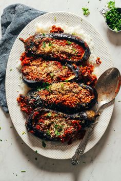 stuffed eggplant with marinara sauce and parmesan cheese on a white plate