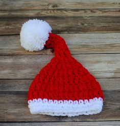 "Santa hat was made using acrylic yarn in red and white. Trim and pom pom was made using white acrylic yarn.  Beautiful hat for the holidays and for photo shoots. Perfect for baby's first pictures. This Santa hat can be made in other colors. Convo/e-mail me for details. Sizes available:  Newborn - 11\" 0-3 months - 12-14\" 3-6 months - 14-16\" 6-12 months - 17\" 12-24 months - 18\"-19\" Care instructions: Wash gentle - dry flat. This will help maintain shape longer. Thanks for looking :) http://www.etsy.com/shop/Monarchdancer Check out my other baby hats.. http://www.etsy.com/shop/Monarchdancer?section_id=6924413 My other photo props http://www.etsy.com/shop/Monarchdancer?section_id=6208364" White Crochet Hat For Winter Gift, Winter White Crochet Hat As Gift, White Christmas Hat As Gift, White Crochet Beanie Hat As Gift, White Christmas Cap, White Christmas Holiday Hat, Newborn Santa Hat, Baby Christmas Hat, Baby Santa Hat