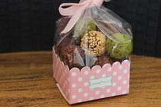 a pink polka dot box filled with assorted treats