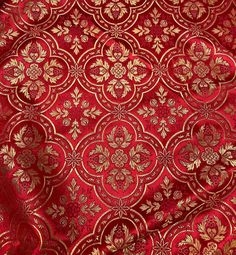 red and gold brocaded fabric with golden flowers on it, in the background