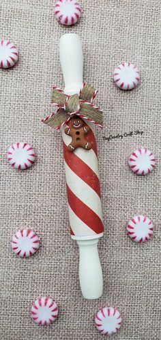 a candy cane with a gingerbread cookie sticking out of it