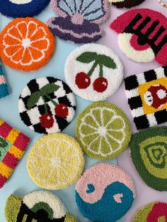 several crocheted coasters with fruit and vegetables on them, all in different colors