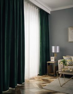 a living room filled with furniture and green curtains