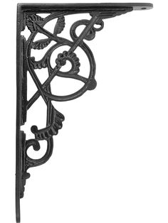 an ornate iron shelf bracket on a white background