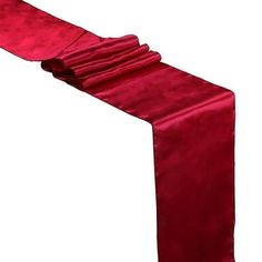 a red satin table runner with ruffled edges