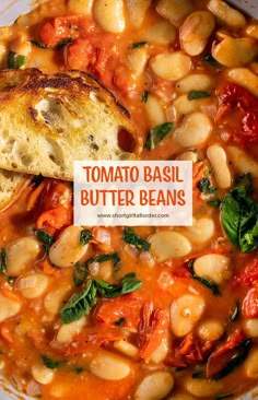 a bowl of tomato basil butter beans with a piece of bread on top and the words tomato basil butter beans above it