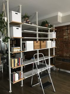 a room with a ladder, bookshelf and shelves