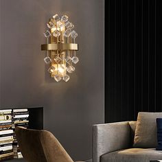 a living room with a couch, chair and lamp on the wall next to bookshelves