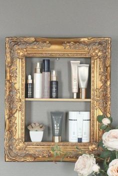 an ornate gold framed shelf with beauty products on it