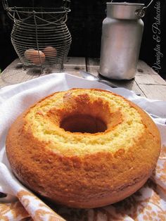 a bundt cake sitting on top of a white napkin next to an egg container