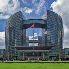 a large building with a red flag on it's side in the middle of a field