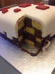 a cake that has been cut in half with red and white icing on it