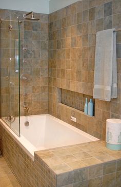 a bathroom with a tub, sink and mirror