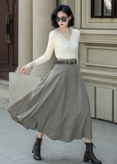 This is a very elegant skirt in wool with a high waist and belt loops, so you can wear it with a belt like the model, and wear it casually with boots and a coat in autumn and winter. DETAIL * 30% wool, 30% fiber, 40% polyester * Polyester lining * Two side Seam pockets * Right zipper closure * Midi calf length * A Line maxi skirt * Perfect for Winter, autumn * Dry clean MODEL SIZE Bust 85 cm(33.4")  Waist 67 cm(26.7")  Height 168cm (5' 6") She wears size XS CUSTOM MADE SERVICE If you * Change other color * Can't find your size in our size Chart * Change the Style * Change the length * Your Height is not Between 5'1" - 5"9" * Your weight is not Between 47 kg - 75kg I can do it for you, It will need some extra fee depending on on your need. Contact with me for more detail. SIZE GUIDE Size va White A-line Skirt For Fall, Elegant A-line Bottoms For Winter, Winter Formal Pleated Skirt, Formal Long Skirt For Fall, Winter Workwear Lined Maxi Skirt, Winter Workwear Maxi Skirt With Lining, Lined Maxi Skirt For Winter Workwear, Elegant Flared Skirt Bottoms For Winter, Elegant Solid Pleated Skirt For Winter