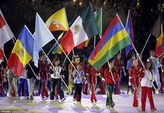 a group of people holding flags on top of a snow covered ground