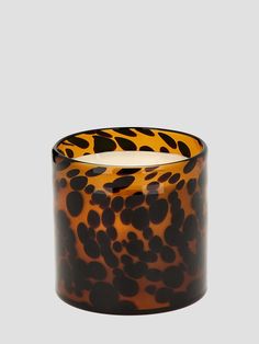 an animal print candle holder on a gray background