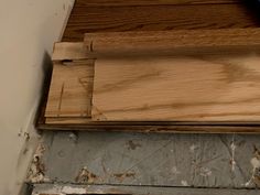 a piece of wood sitting on top of a wooden floor next to a window sill