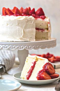 two slices of cake with strawberries on the top and one slice missing from it