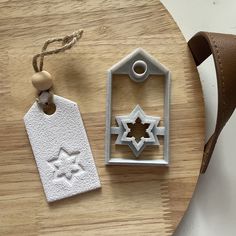 a wooden table topped with two white tags