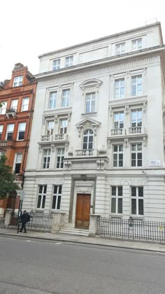 a large white building sitting on the side of a street