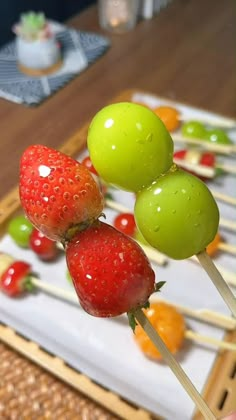 there are fruit on the skewers ready to be eaten