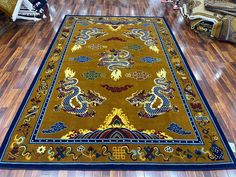 This exquisite Handknotted Tibetan Dragon Rug is a true masterpiece of craftsmanship, blending traditional artistry with rich cultural symbolism. Each knot is meticulously tied by hand, creating a dense, durable weave that showcases the intricate beauty of Tibetan design. The central motif of the rug features a majestic dragon, symbolizing strength, wisdom, and protection--core elements in Tibetan mythology. The dragon is often depicted in dynamic poses, surrounded by clouds or flames, embodying the power and spiritual energy associated with these revered creatures. Crafted from high-quality wool, the rug is soft to the touch yet incredibly resilient, offering both comfort and durability. The vibrant color palette, featuring deep reds, rich blues, golds, and greens, is carefully chosen for Tibetan Design, Dragon Rug, Tibetan Dragon, Majestic Dragon, Meditation Area, Vibrant Color Palette, Spiritual Protection, Spiritual Energy, Dynamic Poses