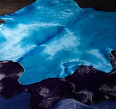 a blue and black area rug on top of a wooden floor