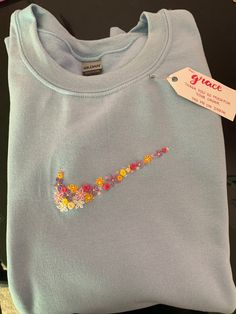 a blue t - shirt with the word grace written on it and flowers all over it