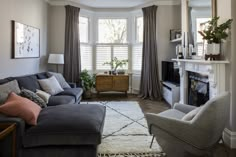 a living room filled with furniture and a fire place