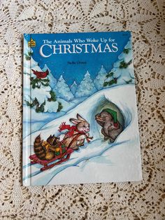 the animals who made life for christmas book sitting on a lace doily covered tablecloth