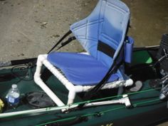 a blue chair sitting on top of a green boat