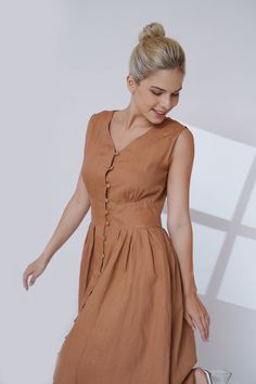 Simple and elegant, this linen dress is made from 100% linen, featuring V-neckline, button down, sleeveless and classic A-shape. Handcrafted in our studio to your specific measurements and customization preferences, with a wide range of color options. ✓DETAILS - A-line silhouette - Sleeveless, front buttons - Seam side pockets - 100% linen, medium weight, free-shrinkage. All our linen is pre-washed for an amazingly soft feel. - French seam, clean and meticulous ✓COLOR The color shown is Bronze Brown A29. You can select any color from our color chart; refer to this link for the most recent and full color updates: https://madebygaiavn.etsy.com/listing/1399149538. ✓CUSTOM - Free customization for design alterations to the neck, sleeves, fit style, and the dress length, which is mid-calf with Linen Casual Dress Fitted, Luxury Short Sleeve Linen Dress For Women, Luxury Fitted Linen Workwear Dress, Linen Fitted Dresses, Simple Linen Dress Blouse, Luxury Fitted Linen Dress With Short Sleeves, Luxury Linen Knee-length Dress For Work, Simple Dresses Linen, Linen Dance Dress