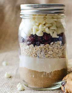 a jar filled with oatmeal and cookies on top of a table next to a cookie