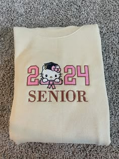 a hello kitty t - shirt with the number 24 on it is laying on the floor