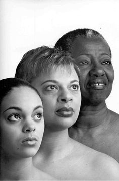 three women and one man are shown in black and white, with the woman's face partially obscured by her chest