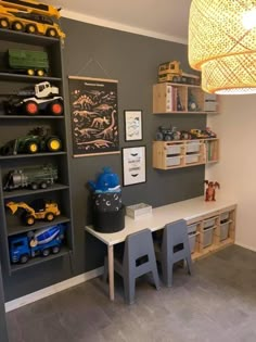 a room with toy trucks and toys on the shelves