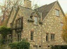 an old stone house with ivy growing on it