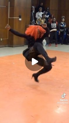 a person jumping in the air with an orange hair