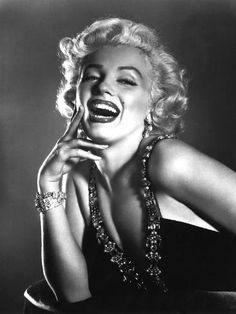 marilyn monroe laughing and posing for the camera