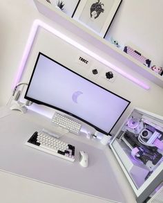 a computer monitor sitting on top of a white desk next to a keyboard and mouse