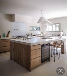 a large kitchen with an island in the middle