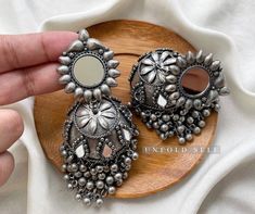 Add elegance and sophistication to any casual day with these silver-toned handcrafted Metal Jhumkies. It's a beautiful pair of handcrafted oxidized silver metal alloy jhumki embellished with Ghungroo and Mirrors. Base Metal- Alloy, Silver, Brass Plating- German Silver Stone- Mirror Sizing-Non Adjustable Type- Jhumka Earring Light Weight Recycled Item Skin Friendly- Lead & Nickel Free in compliance with all International Requirements. Gift - Ideal Valentine, Birthday, Anniversary gift for someone Mirror Jhumka, Oxidised Jhumka, Silver Jhumkas, Stone Mirror, Indian Women Fashion, Oversized Earrings, Silver Jewellery Indian, Indian Jewelry Sets, Valentine Birthday